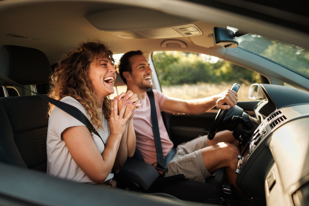 pareja feliz dentro de coche